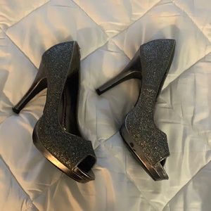 Glitzy 3 1/2 inch silver/black heels. Well worn.